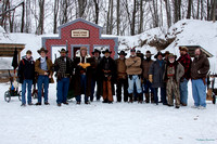 THIRTEEN COWBOYS DRESSED FOR THE COLD.